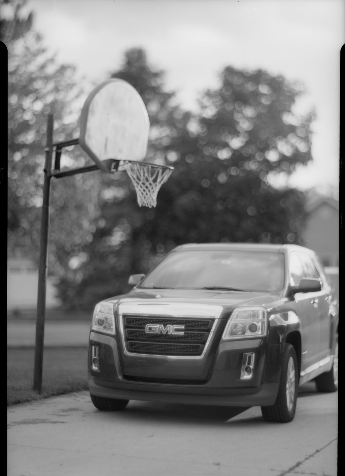 Car in front of basketball hoop